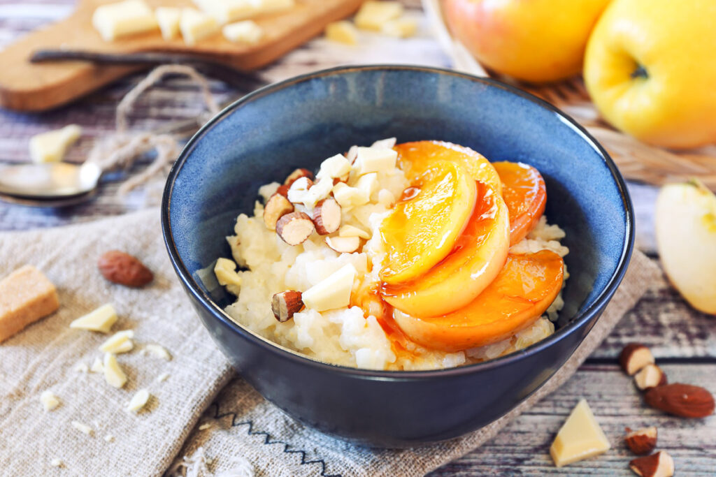 Homemade rice pudding with almonds, white chocolate, and caramelized apples