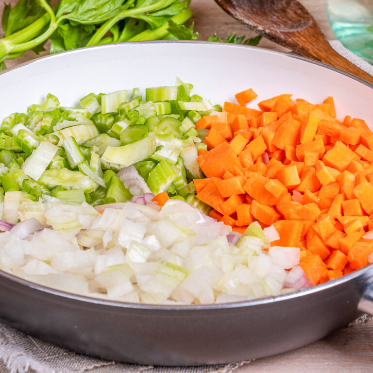 Cooking carrot and celery onion vegetable dressing, chopped ingredients for Mirepoix in a skillet