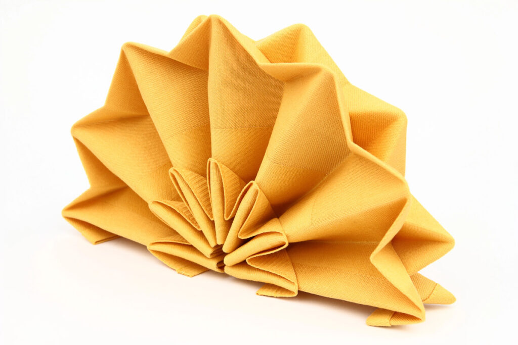 Yellow gold napkin folded intricately